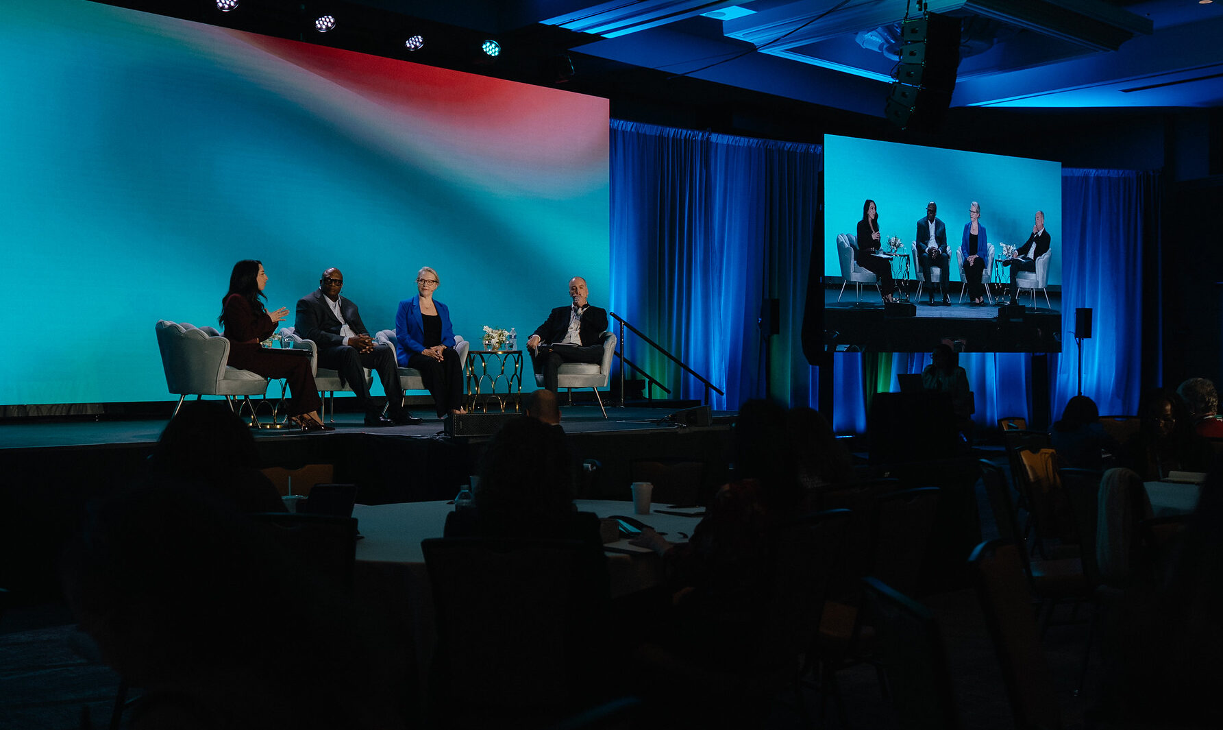 A panel in conversation on stage